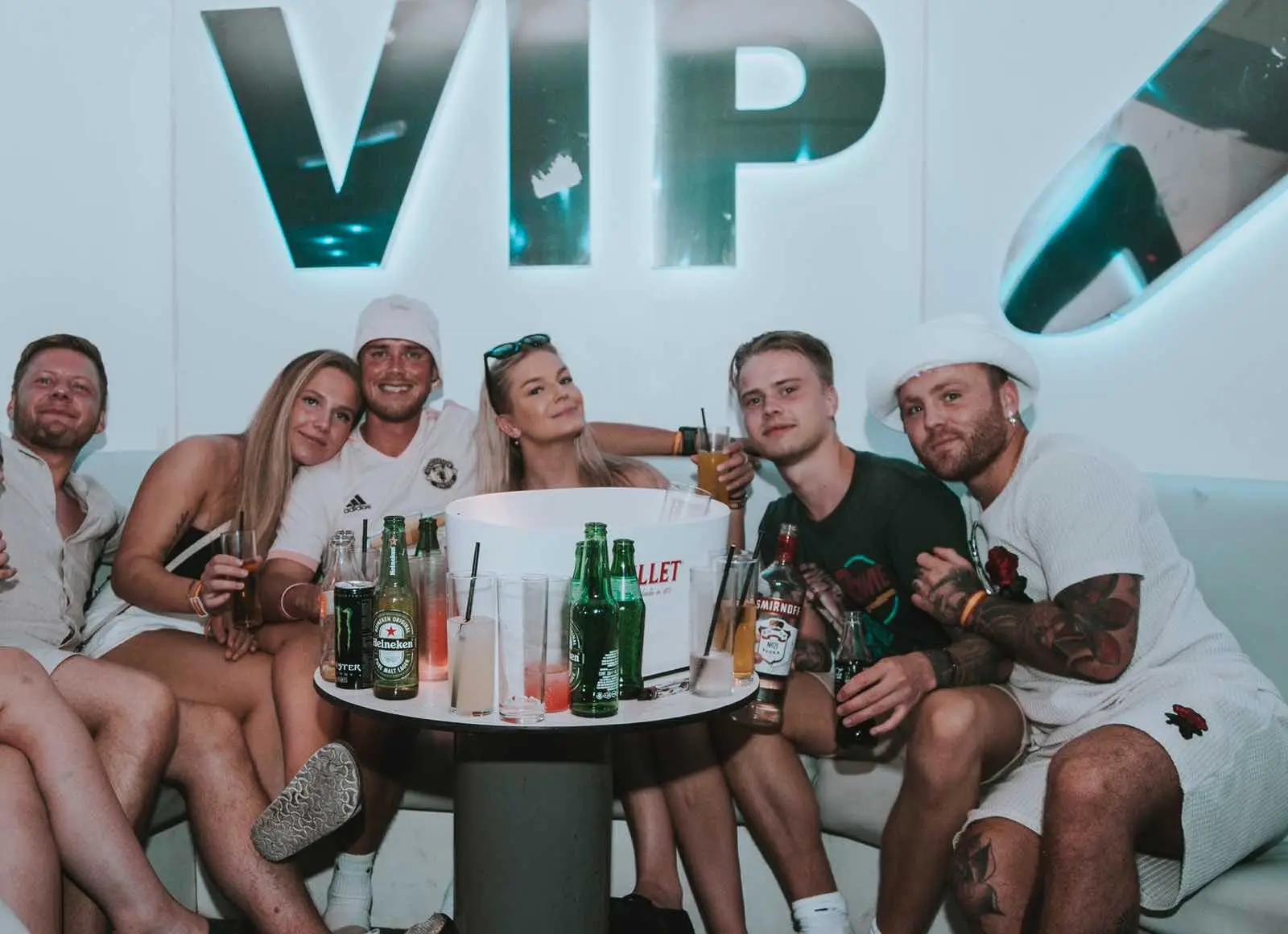 A group celebrating at a VIP table with bottle service