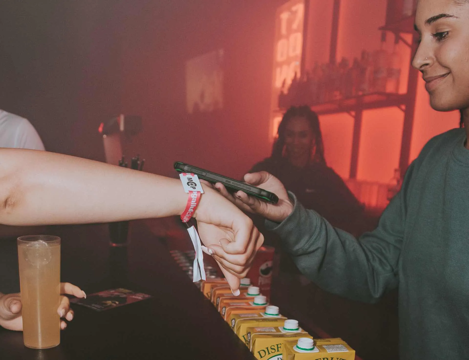 Paying for drinks at the bar with an MCP smart wristband